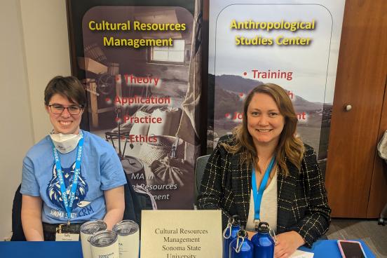 Student and Alumna tabling at SCA event