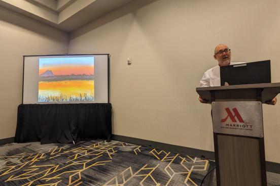 Michael Newland presents at conference