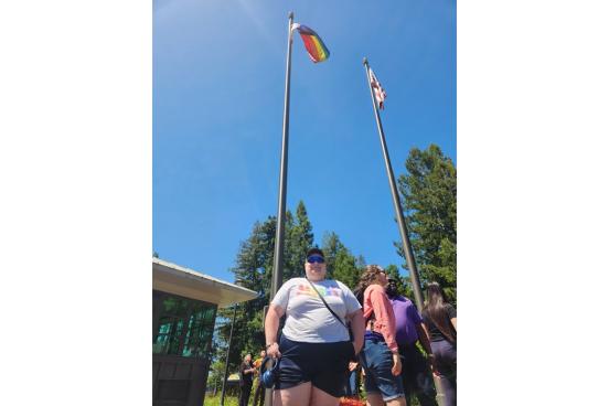 Xander Sterling at the campus flag pole after raising the Pride Flag