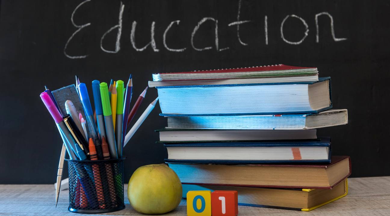 Education stock image of pencils and books with chalkboard