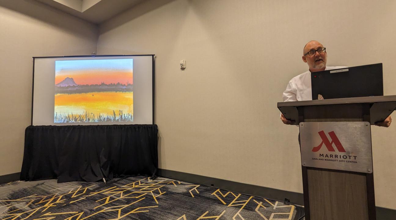 Michael Newland presents at conference