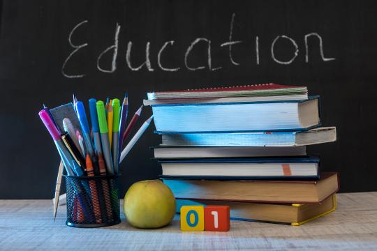 Education stock image of pencils and books with chalkboard